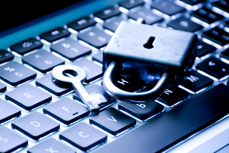 Lock and Key on Top of a Keyboard - Staying Safe on Blossoms Dating Site: Essential Tips to Prevent Scams