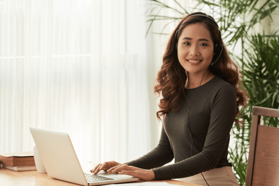 Filipina Woman Wearing a Headset While Working from Home