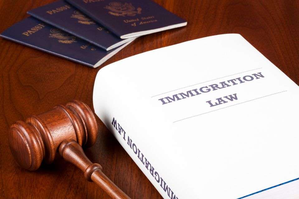 Immigration Law Book with Gavel and Three Passports - How to Get My Filipina Girlfriend to the US - Blossoms Dating Blog
