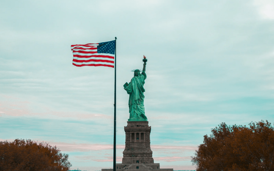 Statue of Liberty with an American Flag