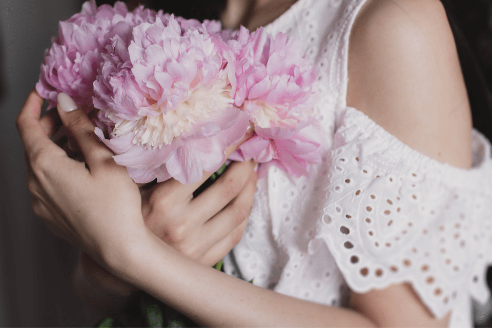 Filipina Woman Holding a Bunch of Flowers - Common Misconceptions about Dating Filipino Women  - Blossoms Dating Blog