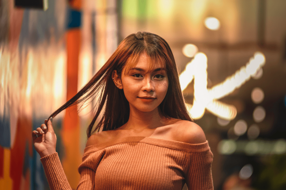 Filipino Woman Holding Her Hair - Why You Should Date a Filipina - Blossoms Dating Blog