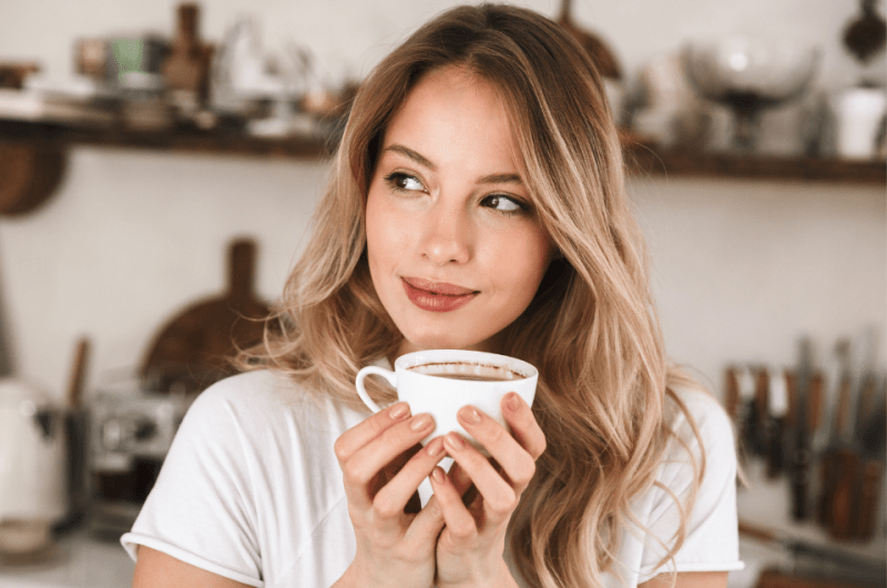 Modern Filipino Woman Drinking Coffee in Her Kitchen