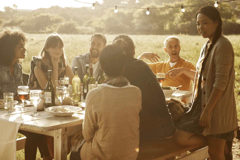 International Community Gathering Over a Shared Meal During Summer