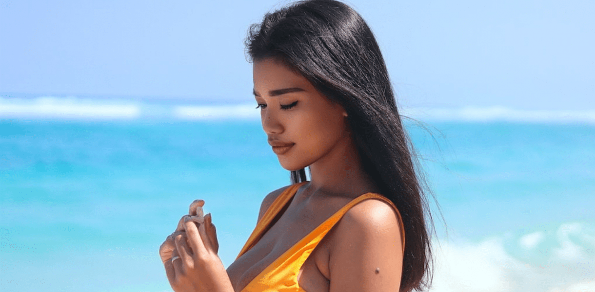 Slim Filipina Collecting Seashells at the Beach