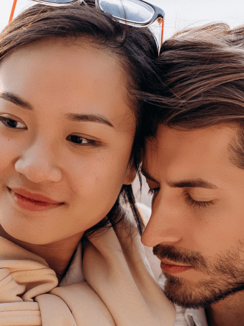 Close up of a Filipina Woman and American Man Hugging While Out on a Date