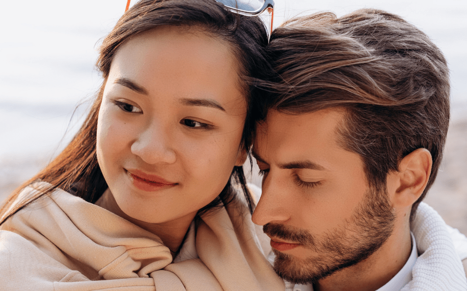 Close up of a Filipina Woman and American Man Hugging While Out on a Date