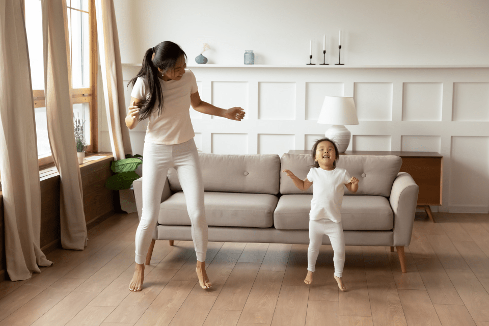 Filipino Single Mom Dancing with Her Daughter at Home - A Guide to Filipino Dating for Western Men - Blossoms Dating Blog