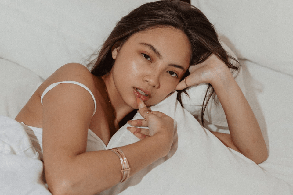 Sexy Filipina Hugging a Pillow in Bed