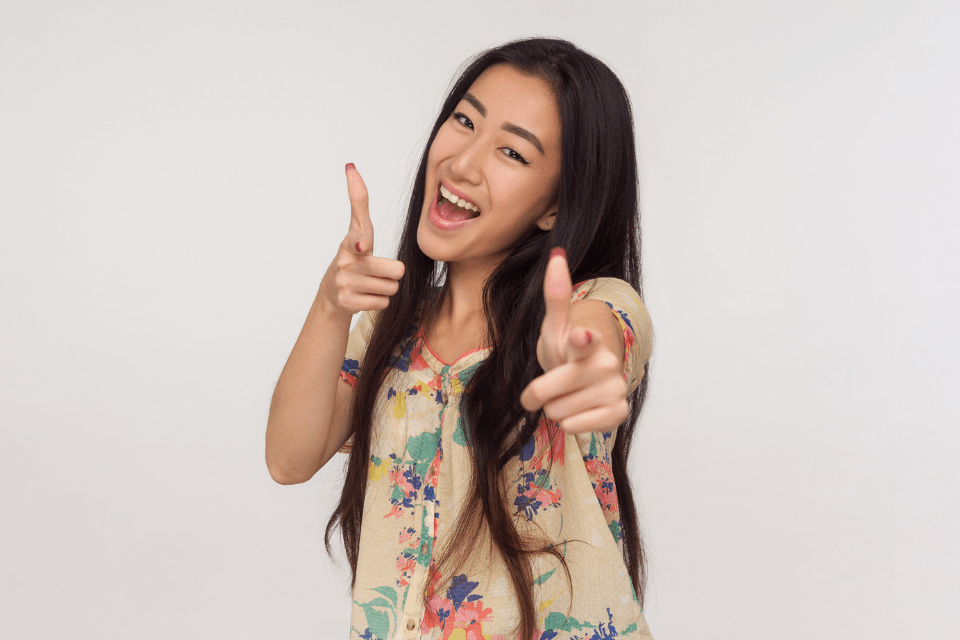 Young Filipino-Chinese Smiling and Gesturing Her Approval