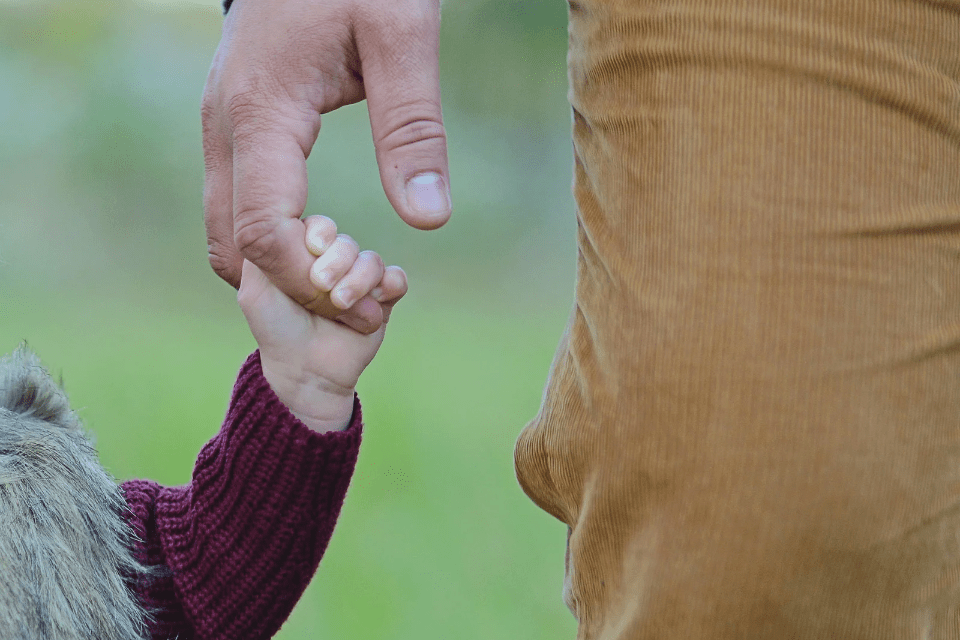 Father Holding His Baby Daughter's Hand