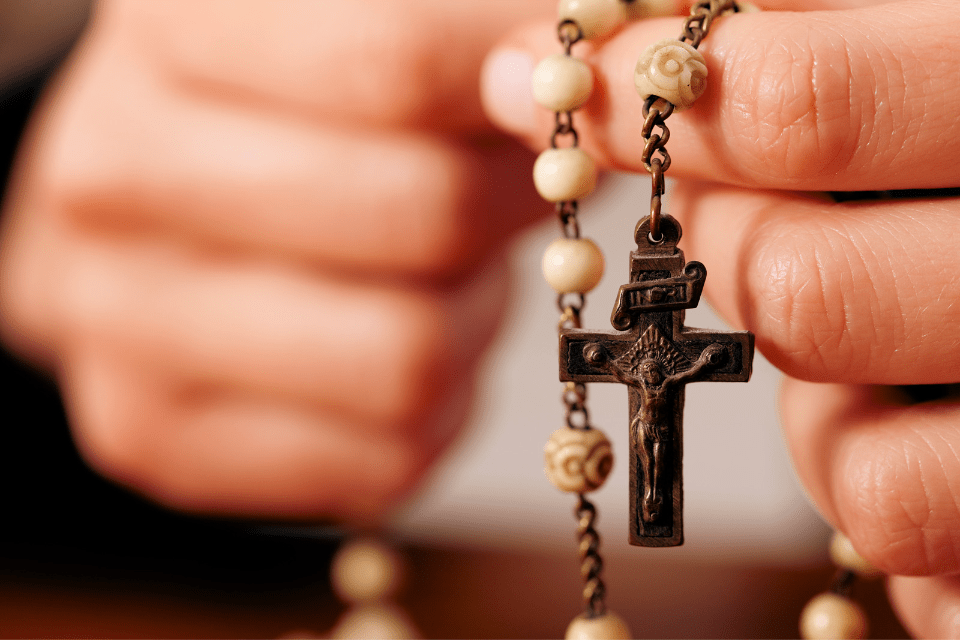 Filipino Woman Praying With the Rosary