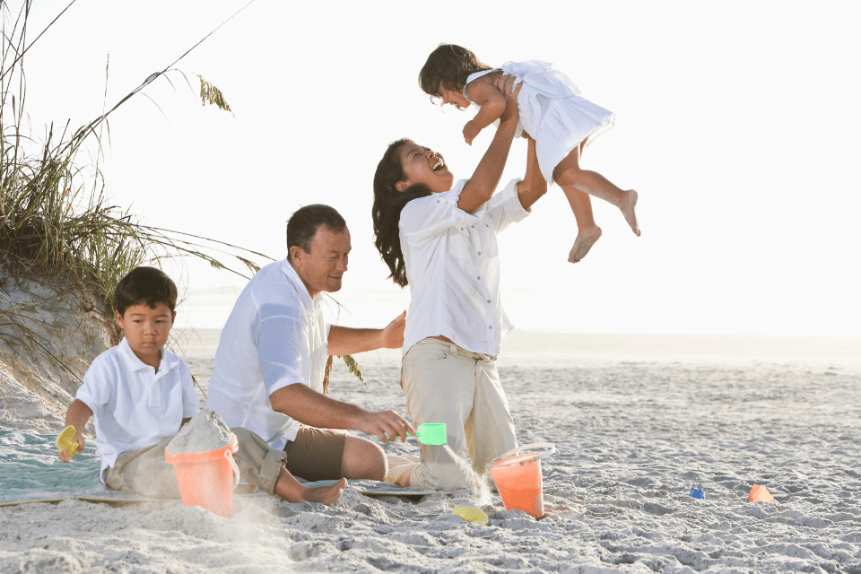 Interracial Family With Kids Playing at the Beach