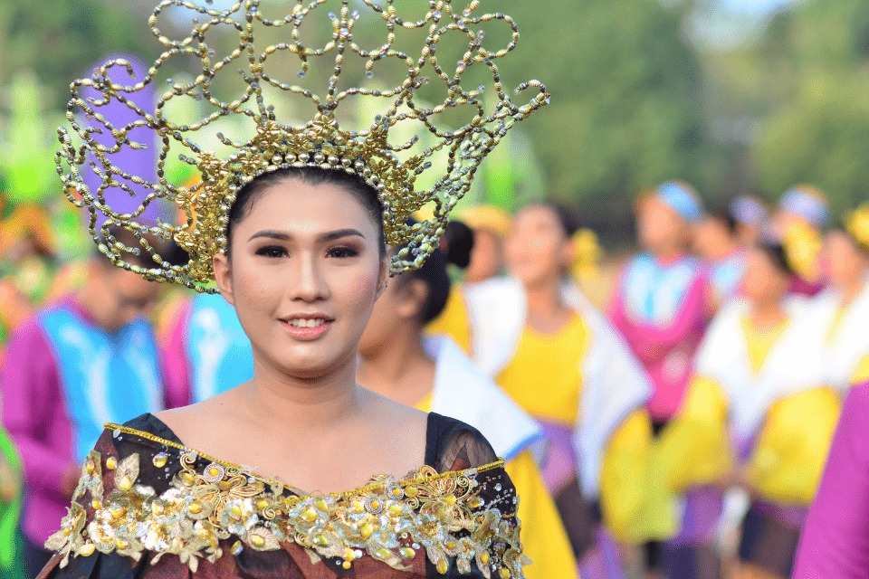 Pretty Christian Filipino Girl in Yellow Floral Dress Wearing a Gold Crown