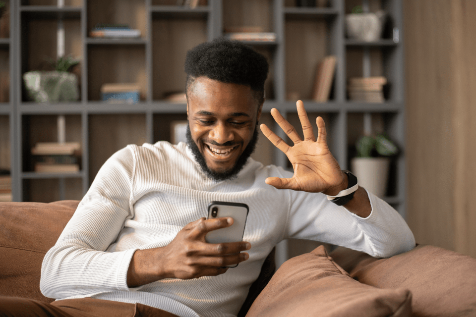 African American man on a video call and having a meaningful conversation with his Filipina online date.
