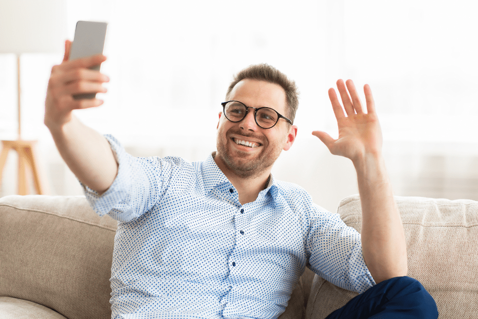 Happy foreign man enjoying a video call with his Filipina partner.