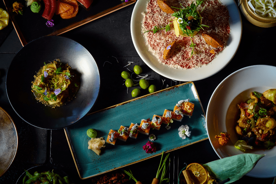 Restaurant table with different culture food plates.