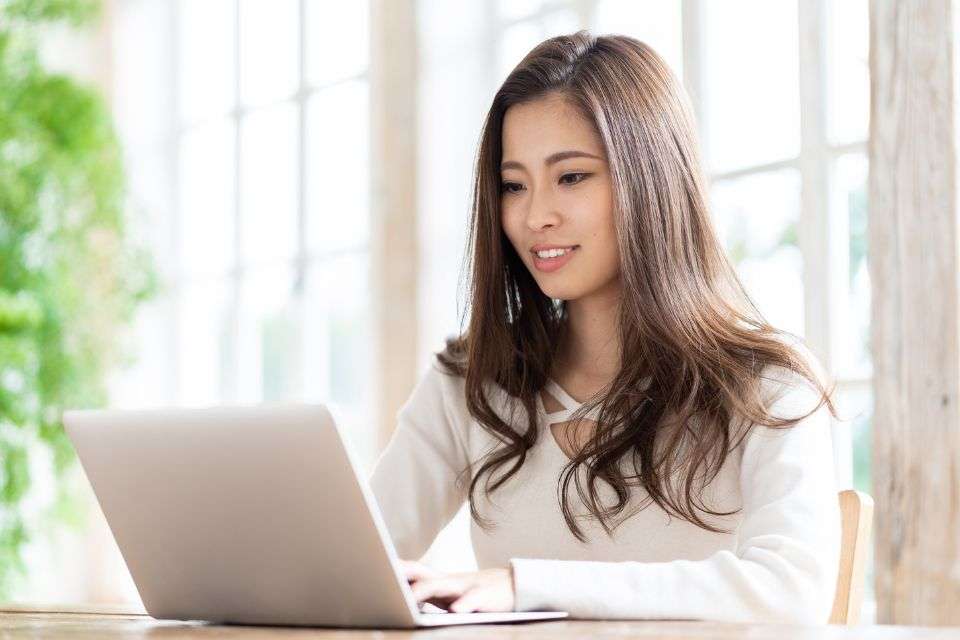 Filipino Woman Using Her Laptop to Communicate Online